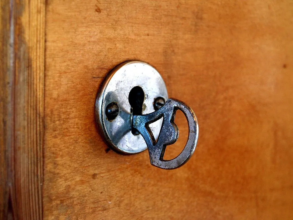 Old key in door lock.